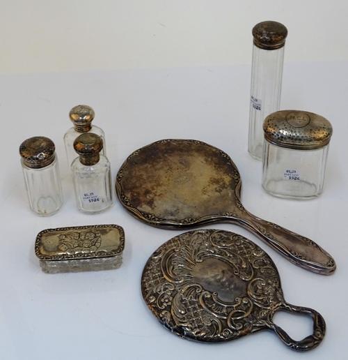 A group of silver mounted toilet and dressing table wares, comprising; two mirrors, a rectangular hairpin box, the lid Chester 1912 and five faceted...