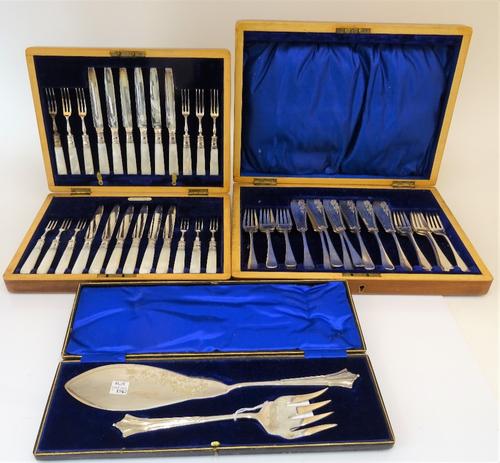 A walnut cased set of twelve pairs of plated mother of pearl handled dessert or fruit knives and forks, a part set of ten fish knives and ten fish...