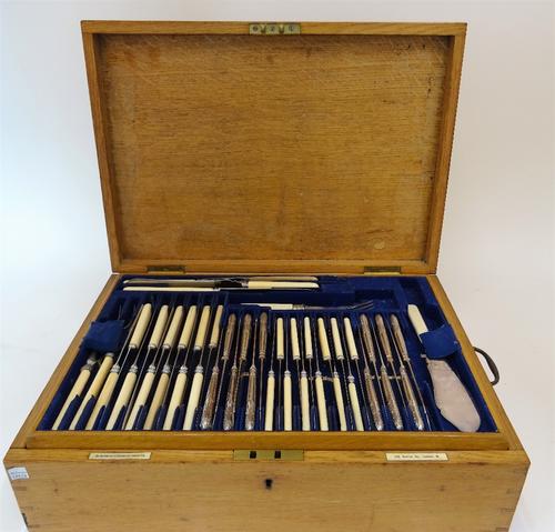 A plated King's pattern canteen of table flatware, comprising; twelve tablespoons, twelve dessert spoons, two sauce ladles, a bread knife, a soup...