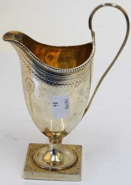 A George III silver helmet shape cream jug, Hester Bateman, London 1783, bright-cut engraved, having beaded borders, on a square plinth base, 16cm...
