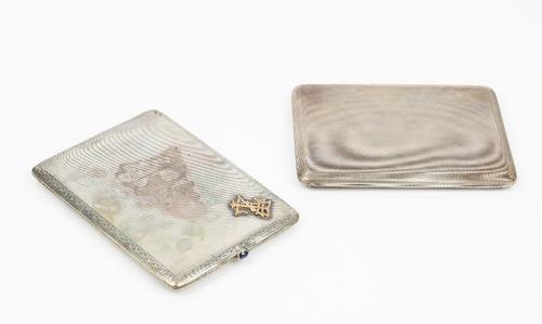 A silver rectangular slide action cigarette case, the exterior with engine turned decoration, London 1934, gross weight 187gms and a German...