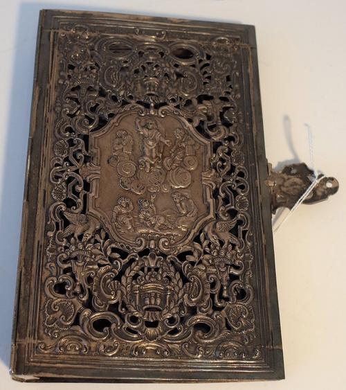 A silver rectangular book binding, 19th century, of Italian style, openwork cast and chased with religious scenes within a shaped cartouche and with...
