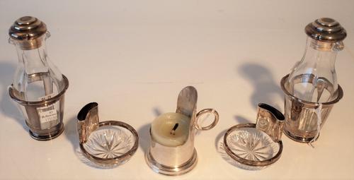 A silver night light candle holder, with a loop shaped handle, Birmingham probably 1914, a pair of foreign silver mounted faceted glass ash...