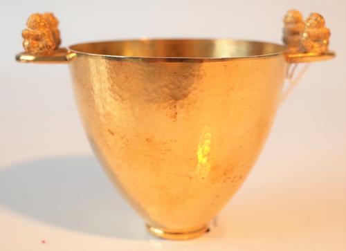 A Greek gilt twin handled cup by Lalaounis, being a copy of a silver gilt vessel the design inspired from the Proto-Corinthian period (7th century...