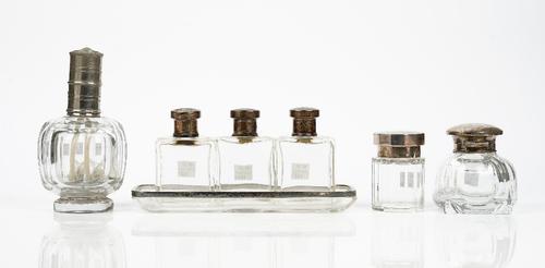 A German silver mounted rectangular glass pen dish, detailed 925, length 23cm, three rectangular glass toilet bottles, the tops detailed 800, a...