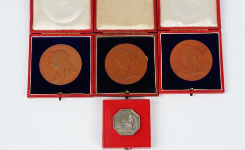 Three Victorian bronze medallions commemorating the 1897 Diamond Jubilee, each diameter 5.5cm, with the original cases and a silver French octagonal...