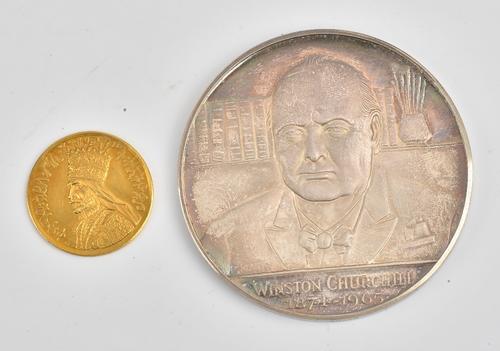 An Ethiopian gold medallion, weight 6.4gms, with a case and a silver medallion commemorating Winston Churchill 1874-1965 with a Spink & Son case (2).