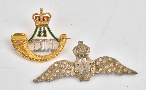 A 9ct two colour gold, green and red enamelled military brooch, designed as the badge of The Durham Light Infantry, Birmingham 1967, gross weight 4.9...