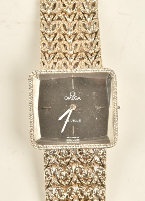 An Omega De Ville white gold rectangular cased ladies bracelet wristwatch, with a signed circular jewelled movement, the signed metallic grey dial...