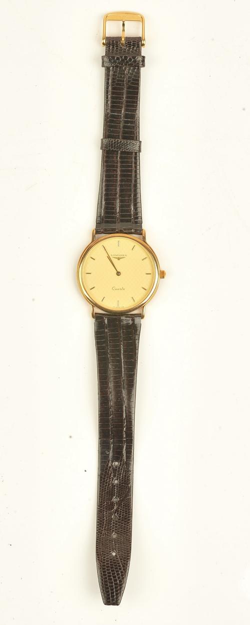 A Longines Quartz gilt metal fronted and steel backed gentleman's wristwatch, the signed gilt dial with gilt hands and gilt baton numerals, on a...
