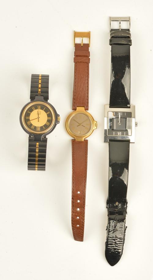 A Dunhill quartz steel curved rectangular cased gentleman's wristwatch, the signed black and silvered dial with silvered Roman and baton shaped...