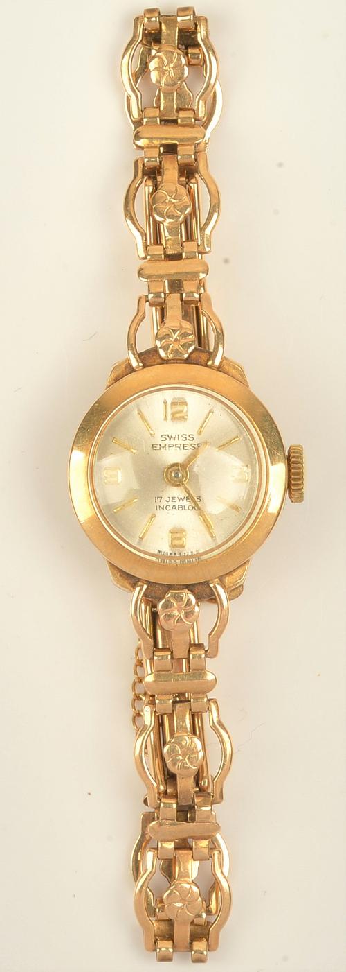 A Swiss Empress 9ct gold lady's bracelet wristwatch, the signed silvered dial with gilt Arabic and baton shaped numerals, the 9ct gold bracelet with...