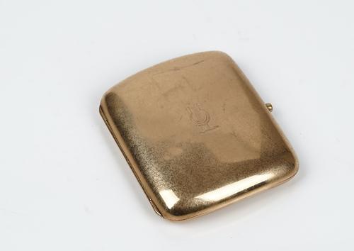 A 9ct gold curved rectangular cigarette case, engraved within and crest engraved to the front, (the hallmark rubbed), gross weight 86gms.