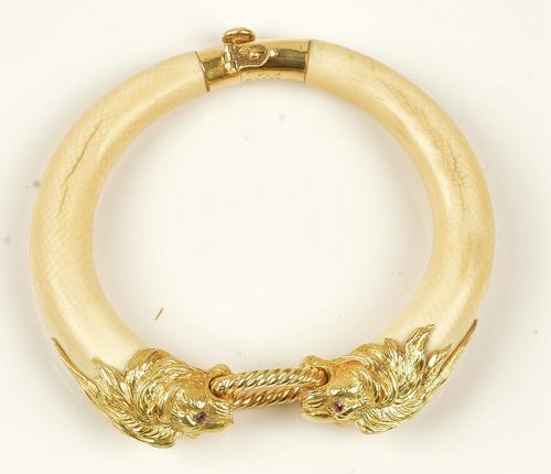 COLLECTED 12.03.21 A Van Cleef & Arpels gold and ivory bangle, circa 1974, of twin section form, the front terminating as two lions' heads, having...