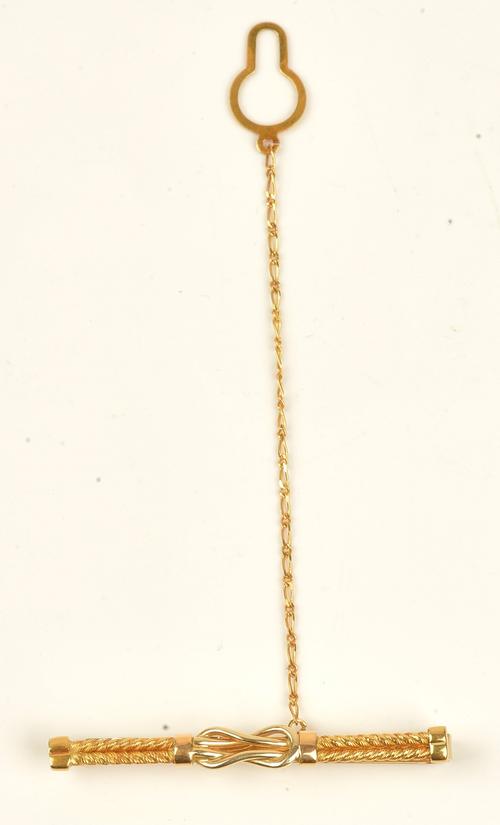 A gold tie slide in a ropetwist and knot design, detailed 750 CARNIANI, with a safety chain, weight 6.6 gms, with a case.
