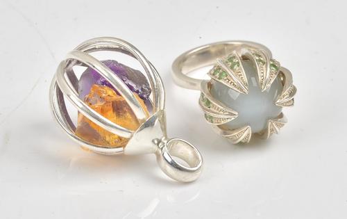 A silver, diopside and quartz cat's eye dress ring, designed as a flower bud, ring size O and a half and a pendant enclosing an amethyst crystal and...