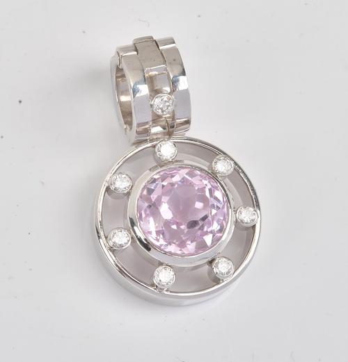COLLECTED 06.08.2021. A kunzite and diamond pendant, collet set with the circular cut kunzite to the centre, in a surround of seven collet set circular cut diamonds,...