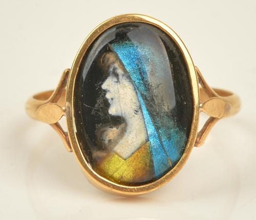 A French gold ring, mounted with an oval Limoges enamel, designed as the portrait of a lady, ring size M, gross weight 2.3 gms, with a case.