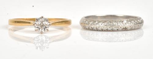 A platinum and diamond set half eternity ring, mounted with two rows of circular cut diamonds, (one diamond lacking), ring size L and a half, gross...