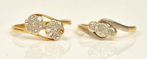 A gold and platinum diamond set ring, in a twin cluster design, mounted with rose cut diamonds (one diamond lacking), detailed PLAT 18 CT, ring size...