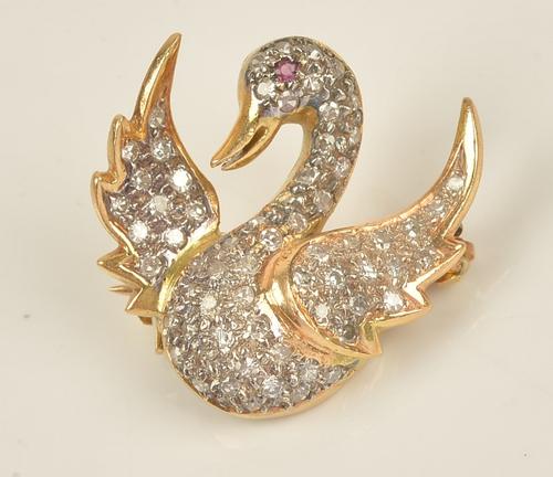 A diamond set pendant brooch, designed as a flying duck, mounted with circular cut diamonds and with a ruby set eye, gross weight 3.3 gms.