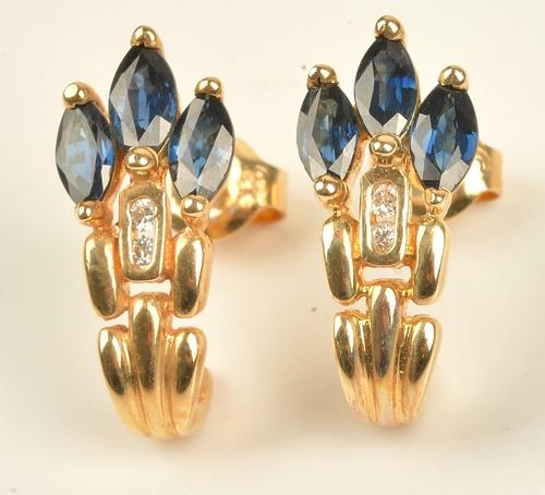 A pair of gold, sapphire and diamond earrings, each mounted with three marquise shaped sapphires and with two circular cut diamonds, detailed to the...