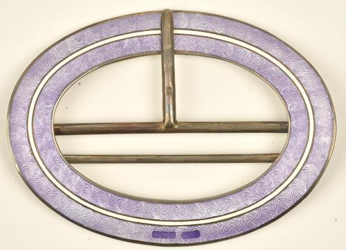A silver, mauve and white enamelled oval buckle, Birmingham 1911, length 7.5cm, gross weight 37 gms, with the original fitted case.