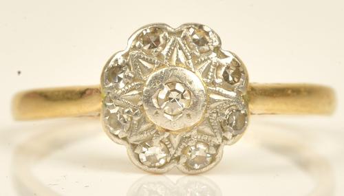A gold and diamond set cluster ring, mounted with a circular cut diamond at the centre, in a surround of eight circular cut diamonds, detailed 18CT,...