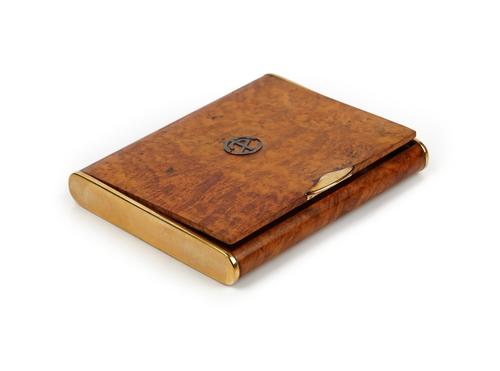 A  European gold mounted rectangular burr walnut hinge lidded cigarette case, retailed by Dunhill, the case exterior with a gold thumb piece and with...