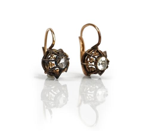 A pair of gold and silver set rose diamond single stone earrings, each mounted with a rose cut diamond within a pierced surround, the tops with...