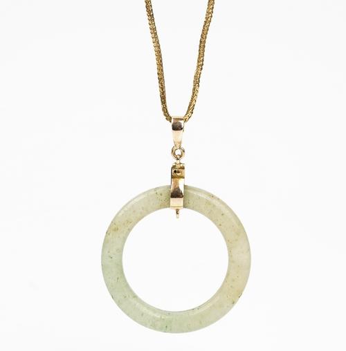 A gold woven link neckchain, detailed 750, on a boltring clasp, detailed 750, weight 7.1 gms and a gold mounted circular pale green stone pendant,...