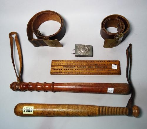 Collectables, comprising; two early 20th century wooden truncheons, 40cm long, two brass Russian bells, a Luftwaffe buckle and a carriage board, (6).