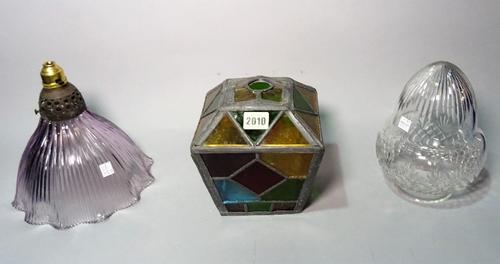 An early 20th century stained glass shade of tapering form, 16cm wide x 19cm high, and two later glass shades, (3).