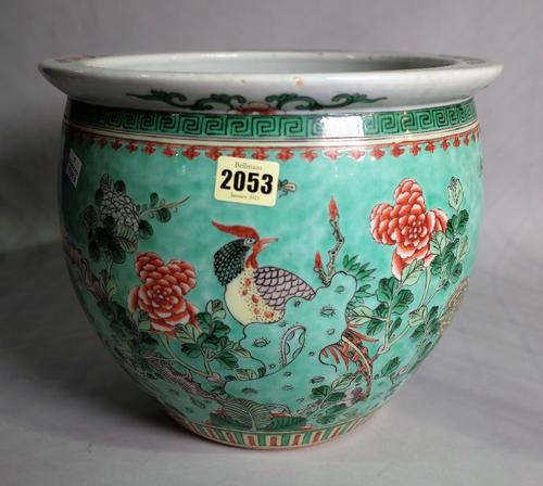 A Chinese porcelain jardiniere, circa 1900, painted in famille-verte enamels with birds in flowering branches against a blue washed ground, (a.f),...