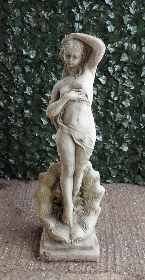 A modern reconstituted stone figure of a female on a shell base, 111cm high.