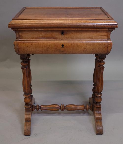 A 19th century French walnut lift top sewing table on reeded baluster supports, 51cm wide x 69cm high.