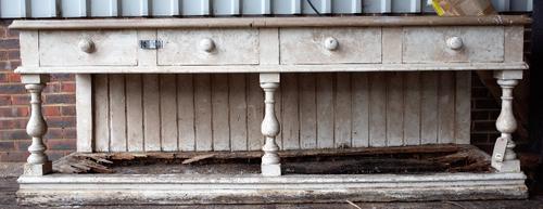 A early Victorian white painted pine dresser base with four frieze drawers on baluster supports and pot board undertier, (a.f), 250cm wide x 90cm...
