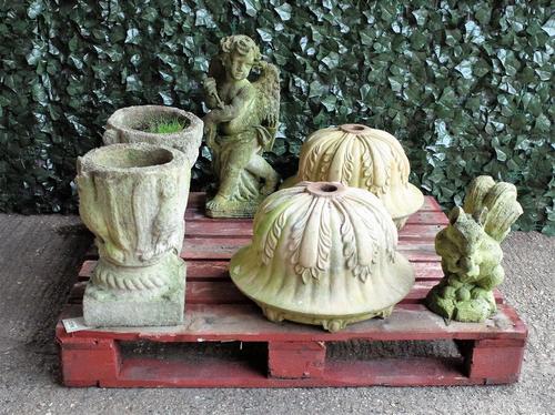 Garden statuary comprising a pair of modern reconstituted stone urns with leaf moulded decoration, lacking bases, 49cm diameter; a reconstituted...