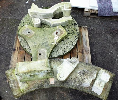 An early 20th century stone circular garden table, 100cm diameter x 70cm high (a.f.), and an early 20th century reconstituted stone curved garden...