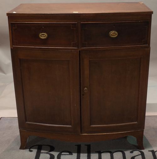 An early 19th century mahogany bowfront side cabinet, with two short drawers over cupboard base, 101cm wide x 116cm high.