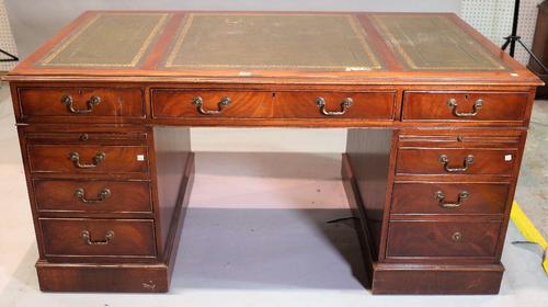 An early 20th century stained beech pedestal desk, 115cm wide x 78cm high.
