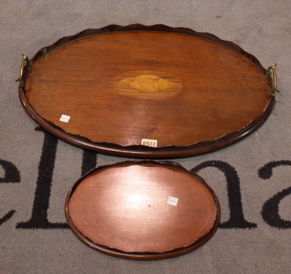 An Edwardian inlaid mahogany twin handled galleried tray, 57cm wide, and another smaller tray, 28cm wide, (2).