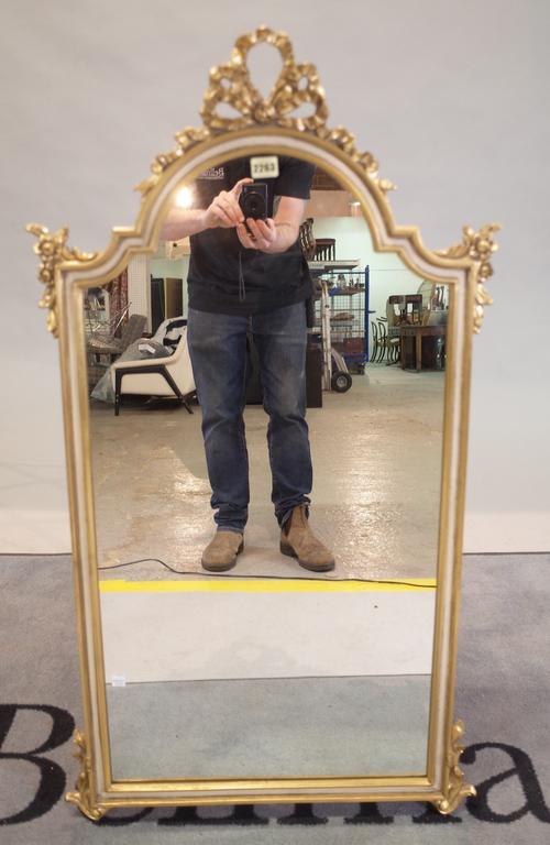 A modern gold painted arch top wall mirror, 58cm wide x 105cm high.