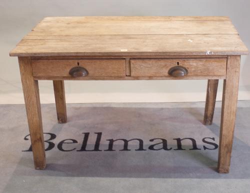 An early 20th century oak two drawer side table, on block supports, 122cm wide x 76cm high x 71cm deep.