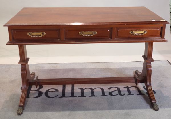 A Regency style stained beech writing desk, with three frieze drawers, on downswept supports, 118cm wide x 75cm high.