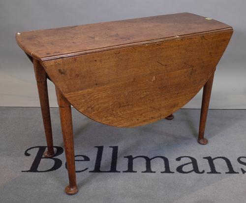 An 18th century and later oak drop flap dining table, on pad feet, 104cm wide x 70cm high.