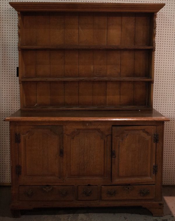 A George III oak mule chest, of raised and fielded paneled construction, later adapted as a dresser with an associated boarded shelved rack, cupboard...