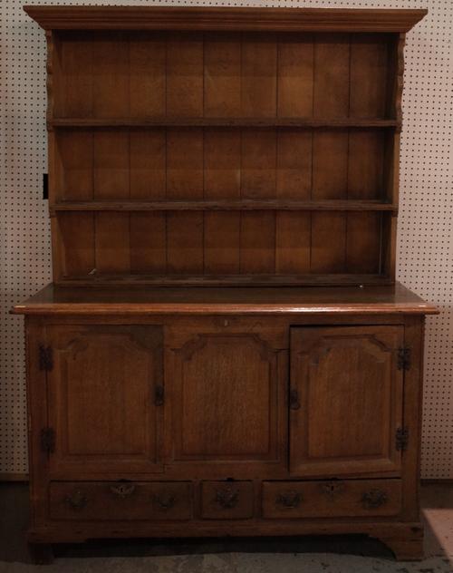 A George III oak mule chest, of raised and fielded paneled construction, later adapted as a dresser with an associated boarded shelved rack, cupboard...