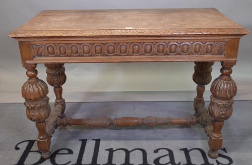 A late 17th century style carved oak side table, the rectangular top, on lobed and fluted turned and carved legs united by stretchers, 107cm wide x...