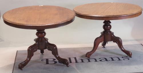 A near pair of Victorian mahogany circular snap top centre tables, on turned column, 100cm diameter x 73cm high, (2).